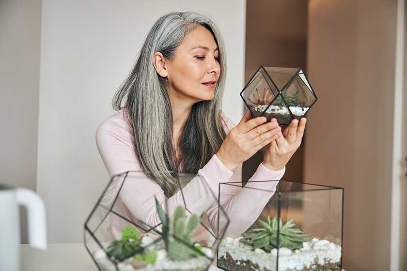 Beautiful woman holding geometric glass succulent florarium