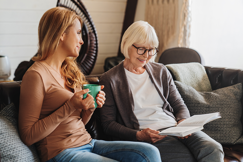 Middle aged woman spending time with her senior mother at home 