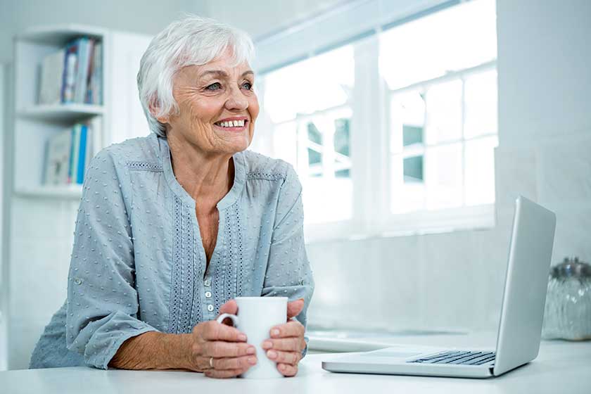 Thoughtful senior woman with coffee mug